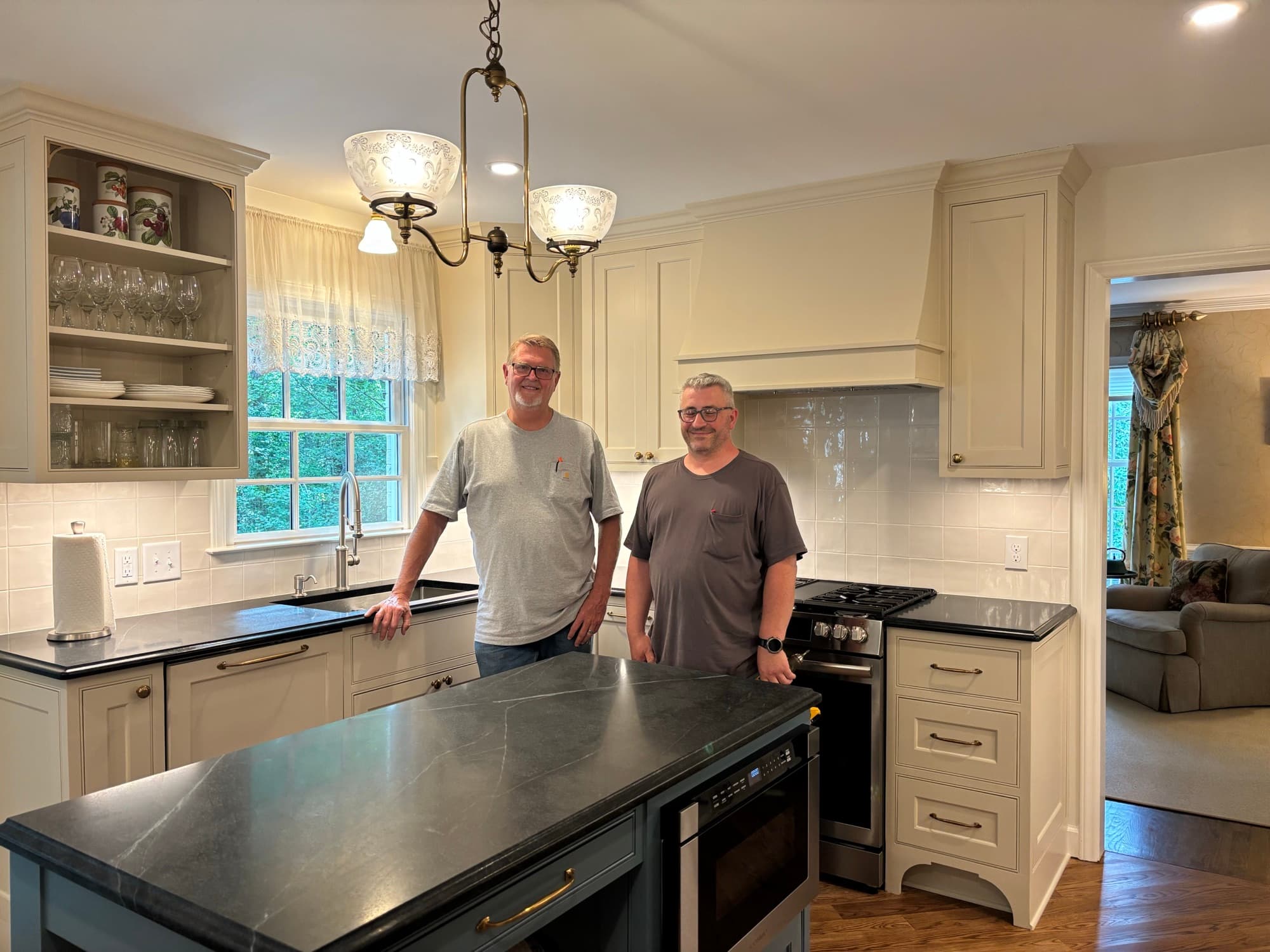 Jim Cooper, in the gray shirt, with his crew in a finished custom kitchen