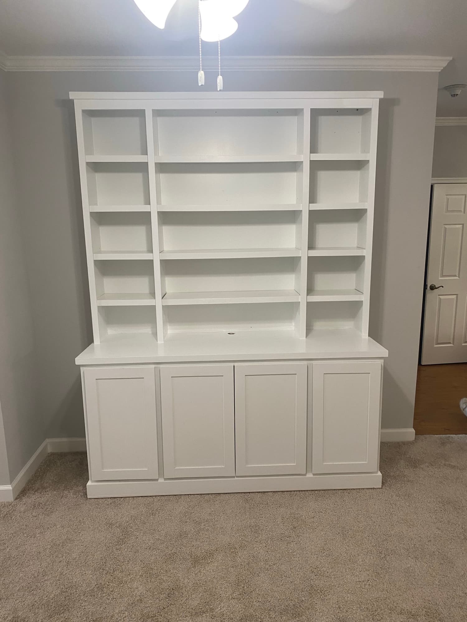 Custom built-in window seat with bookshelves (placeholder photo, replace with a Cooper project)
