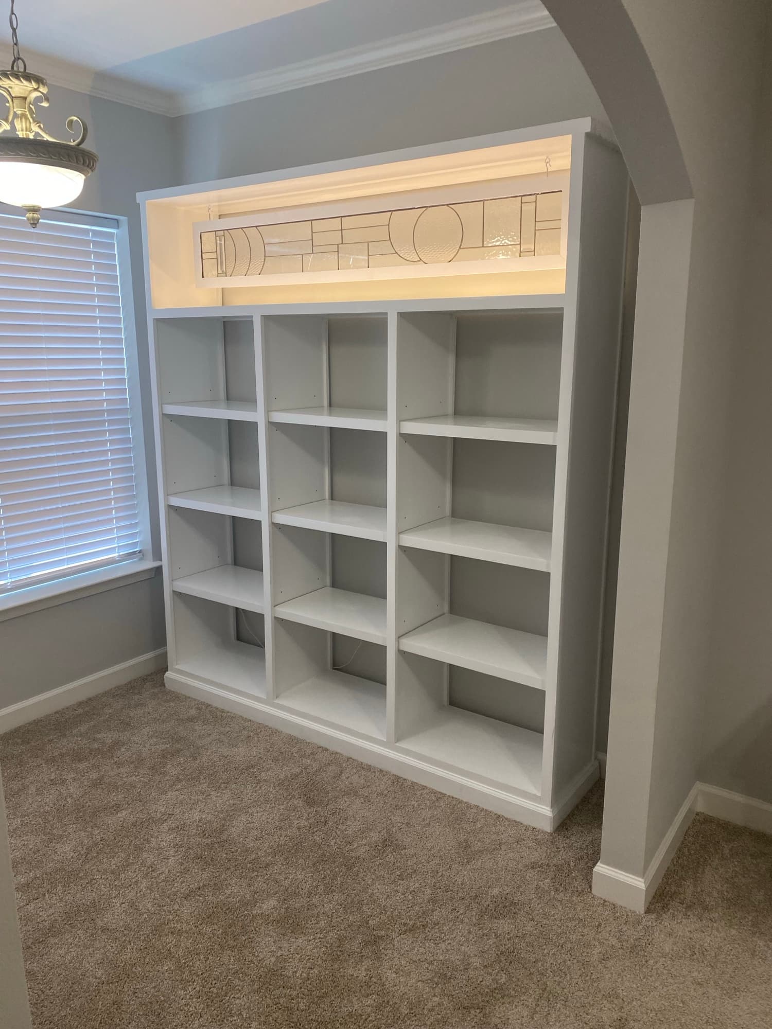 White built-in shelving surrounding a fireplace (placeholder photo, replace with a Cooper project)