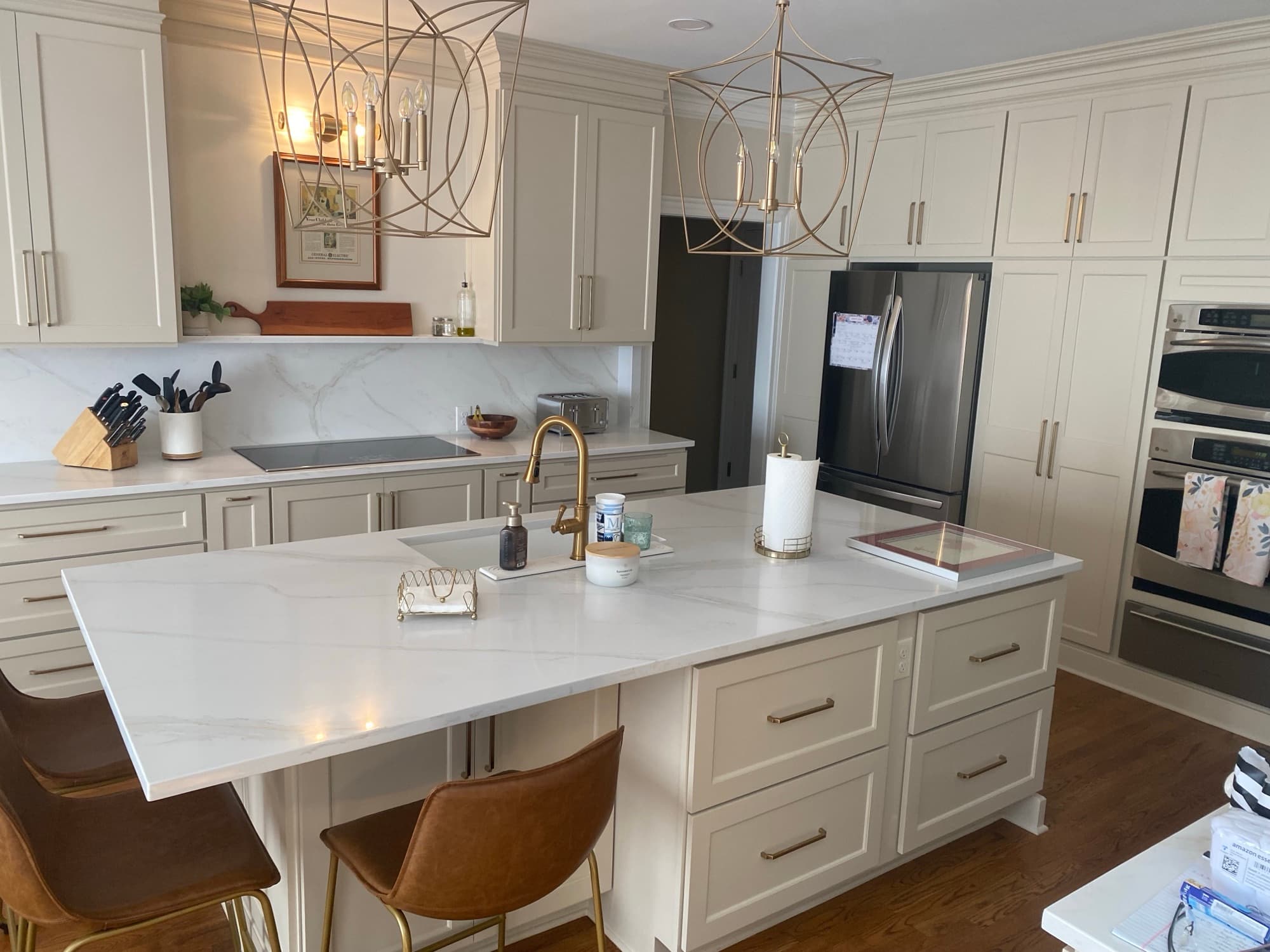 Custom kitchen with cream cabinets and a blue island